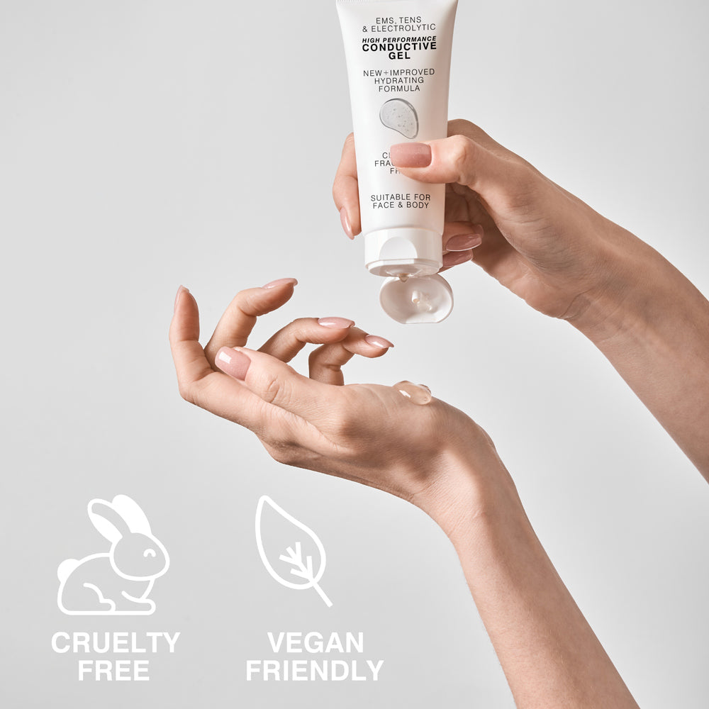A person applies Reviber EMS, TENS, Electrolytic and Micro-Current Toning Conductive Gel (2 x 85ml) from a white tube. CRUELTY FREE and VEGAN FRIENDLY icons highlight its ethical use for electrical muscle stimulation.