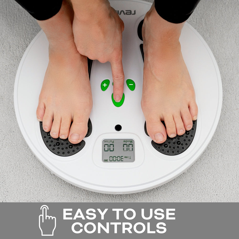 A person stands barefoot on the Reviber Circulation Stim – Electronic Muscle Stimulator by Reviber, using easy-to-use green controls and digital display, ideal for improving lower leg strength. Text below reads: Easy to use controls.