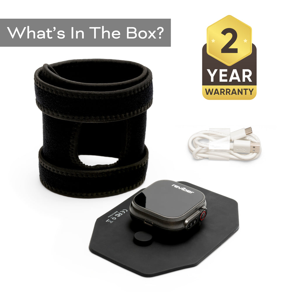 The Reviber Infrared Light Therapy Pad includes a black wearable device with strap, charging pad, and USB cable. “What’s In The Box?” and a 2-Year Warranty badge are at the top. Perfect for red light therapy from Reviber.