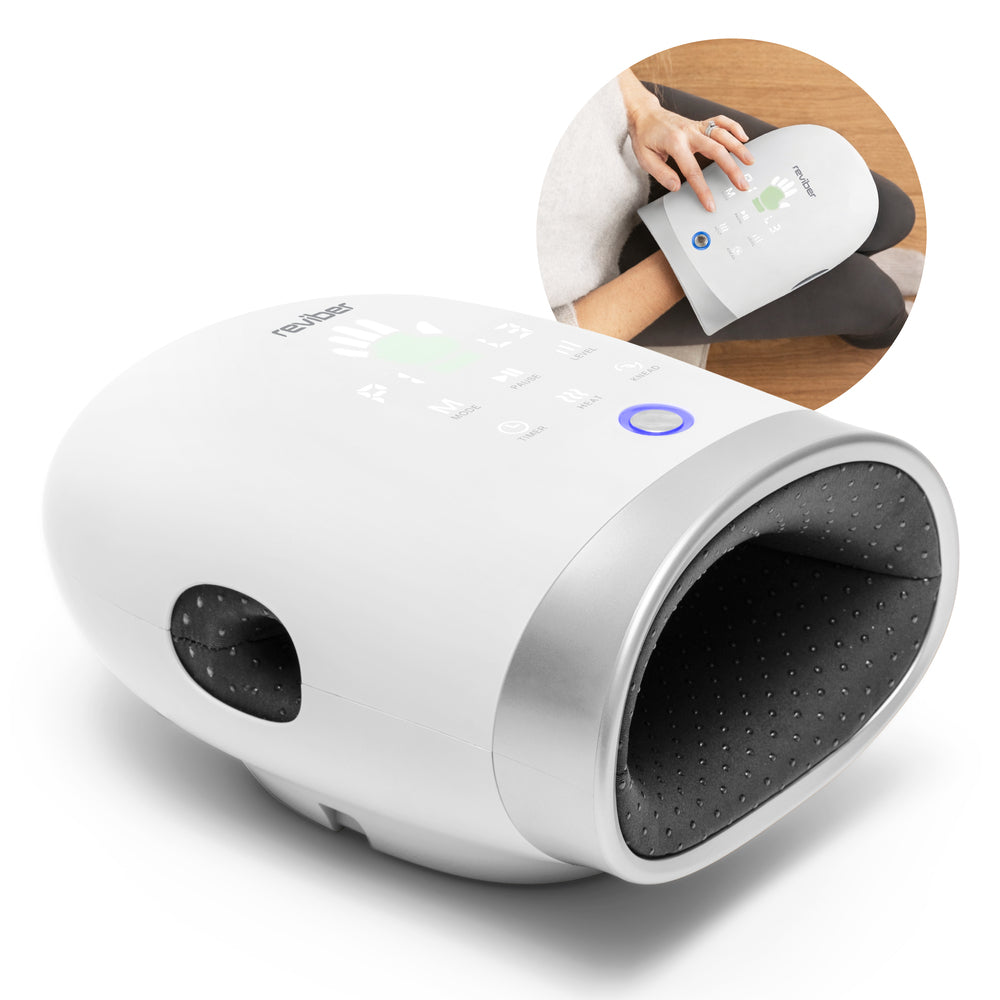 The Reviber Hand Spa Massager with Heat & Finger Stretch by Reviber features a sleek white exterior, a black interior, and control buttons positioned on top; an inset image displays a person seated while using the device on their hand. This compact Reviber massager provides targeted relief comparable to a deep tissue massage gun, making it ideal for soothing tired hands after a long day.