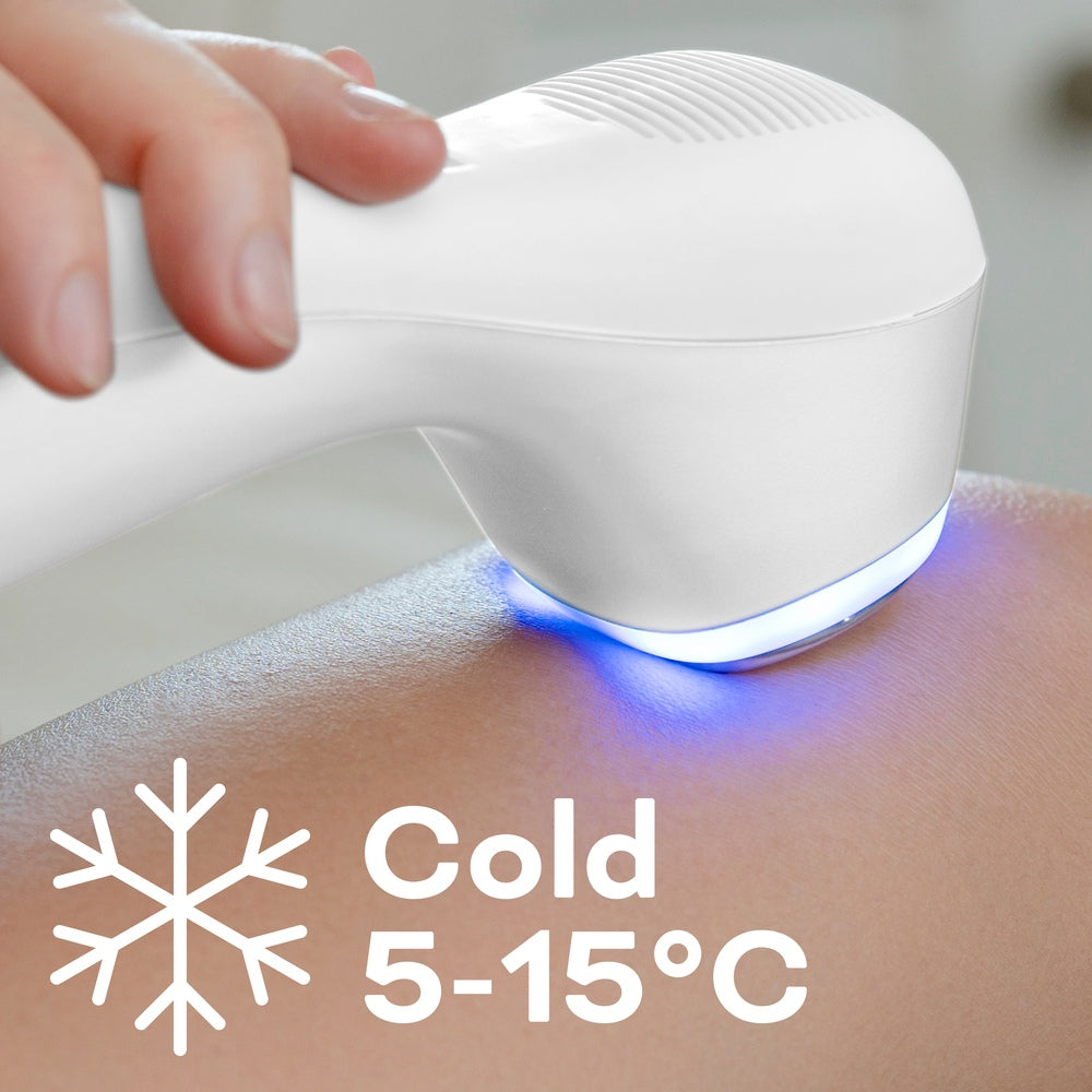 A hand holds the Reviber Hot & Cold Deep Tissue Massager, a white device with a blue light, applying it to skin for an at-home massage. A snowflake icon and text indicate the cold mode: 5-15°C. Brand: Reviber.