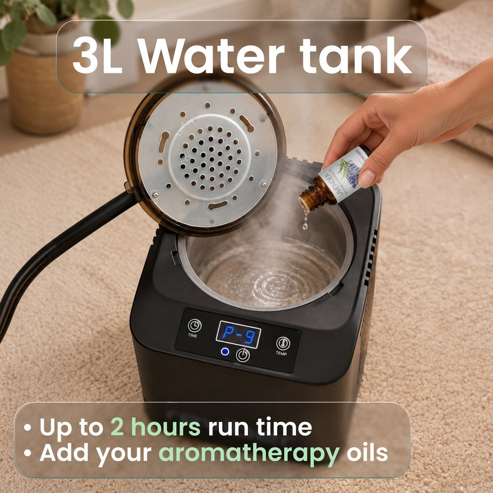 A hand adds essential oil to the steaming water tank of a black Reviber Steam Sauna Pod featuring a digital control panel for at-home relaxation.