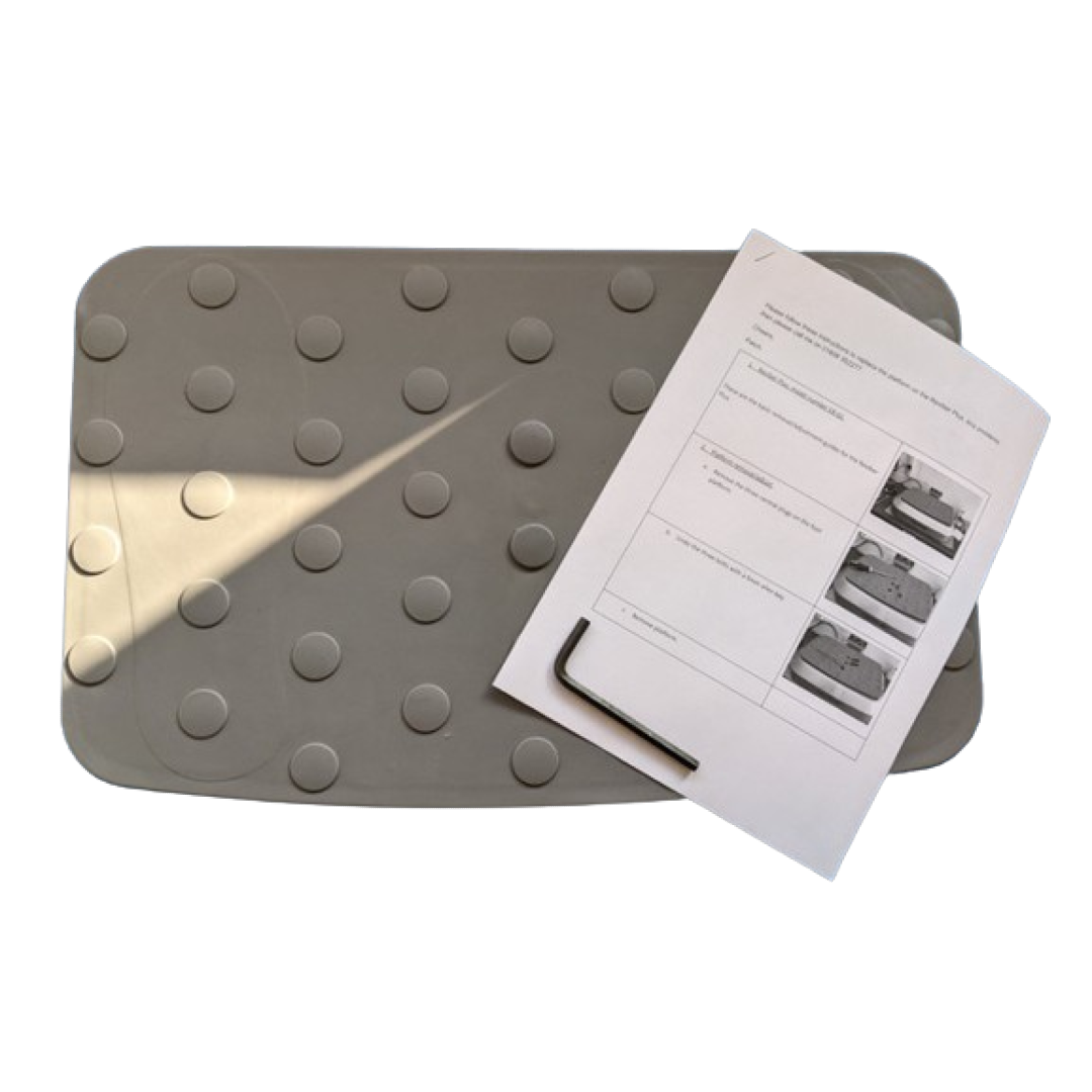 A gray rectangular Reviber Plus replacement platform with circular grips is shown next to printed instructions and a small hex key tool.