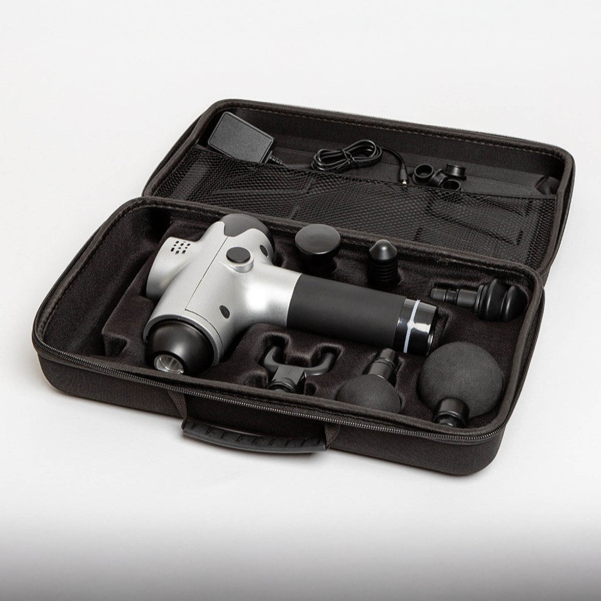 The Reviber Massage Gun by Reviber comes in a black case with multiple interchangeable heads and a charging cable, all securely organized—ideal for deep-tissue massage and muscle recovery anywhere.